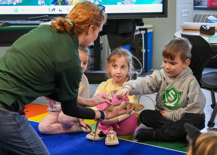 Student touches snake in class