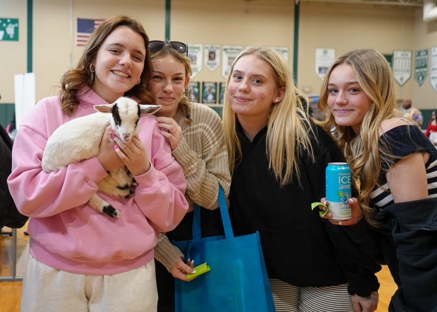 Students pose for photo with baby gate