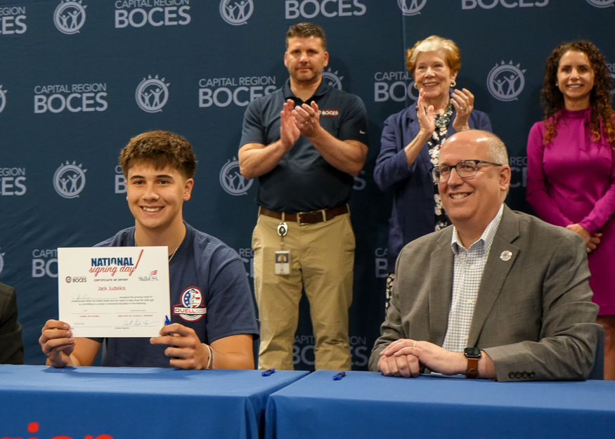 Student poses for photo at Signing Day