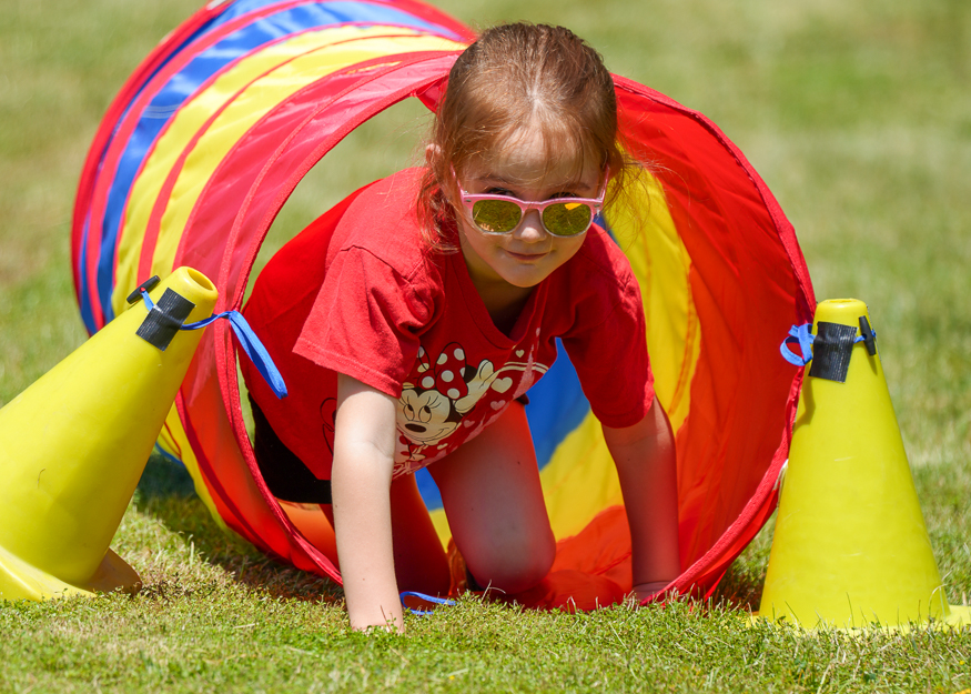 Student crawls through rainbow tunnel