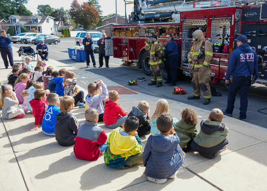Students listen to firefighters