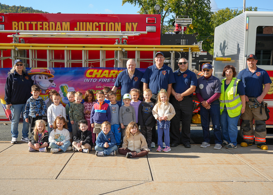 Students pose for photo with firefighters