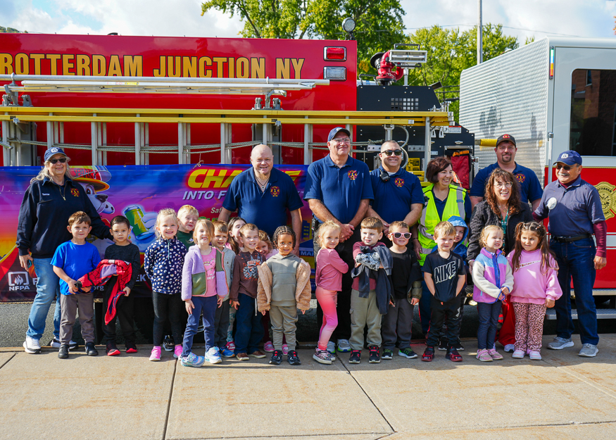 Students pose for photo with firefighters